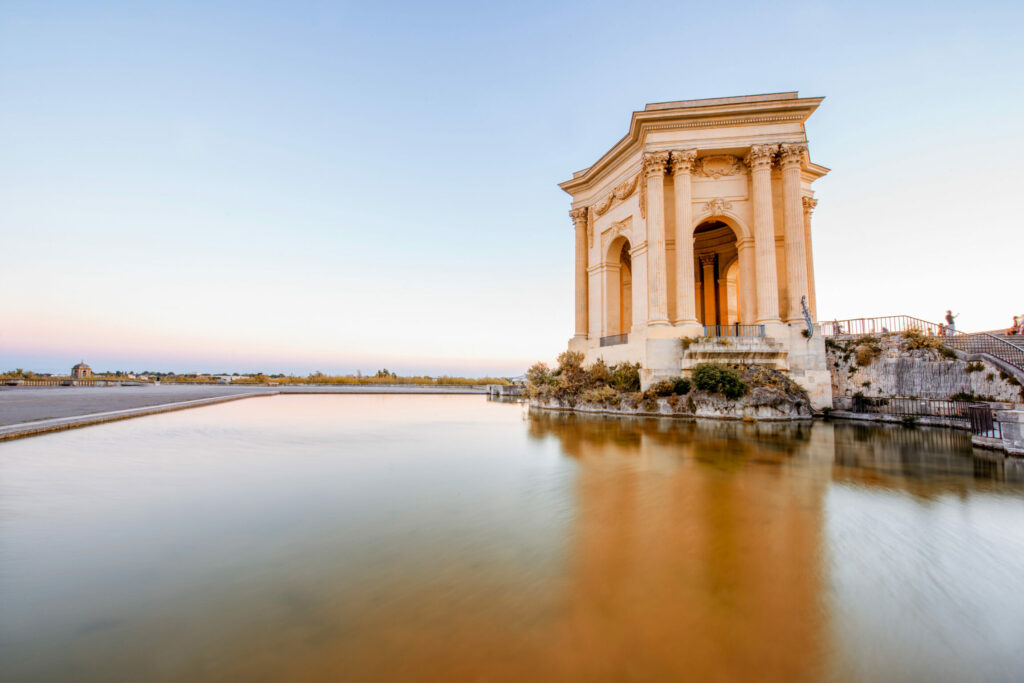 View on the water tower in Peyrou garden with beautiful water reflection during the evening light in Montpellier city in southern France